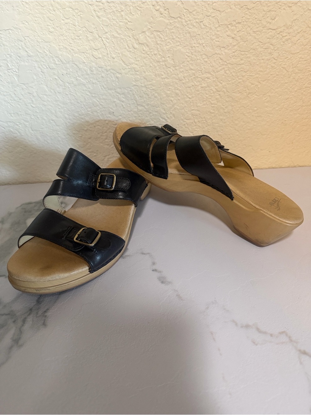 Black leather Dansko Karena slip-on heel sandals